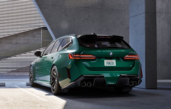 Green BMW M5 Touring parked in garage. | BMW of Palm Springs in Palm Springs CA