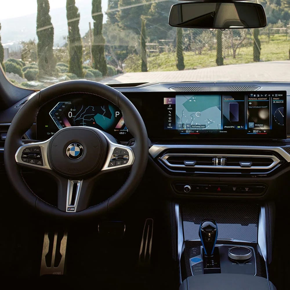 A driver's eye view of steering wheel and controls of the BMW i4 | BMW of Palm Springs in Palm Springs CA