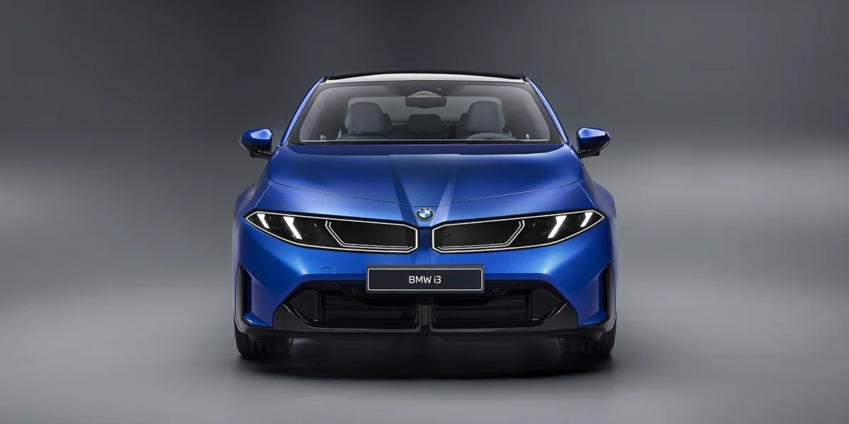 Front view of 2027 BMW i3 electric sedan in studio highlighting grille, headlights, and design.