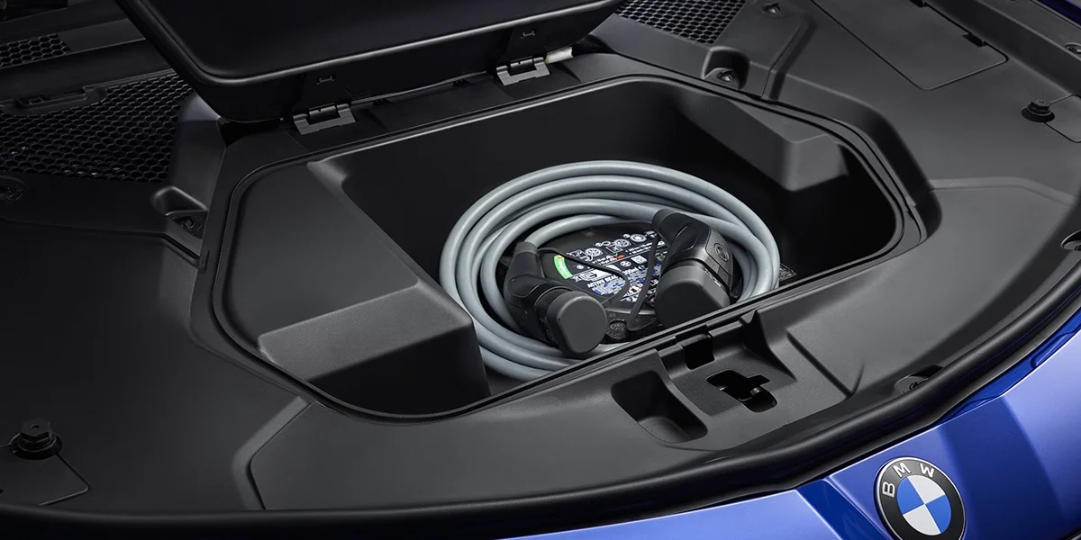 Front trunk storage in 2027 BMW i3 showing charging cable and storage space.