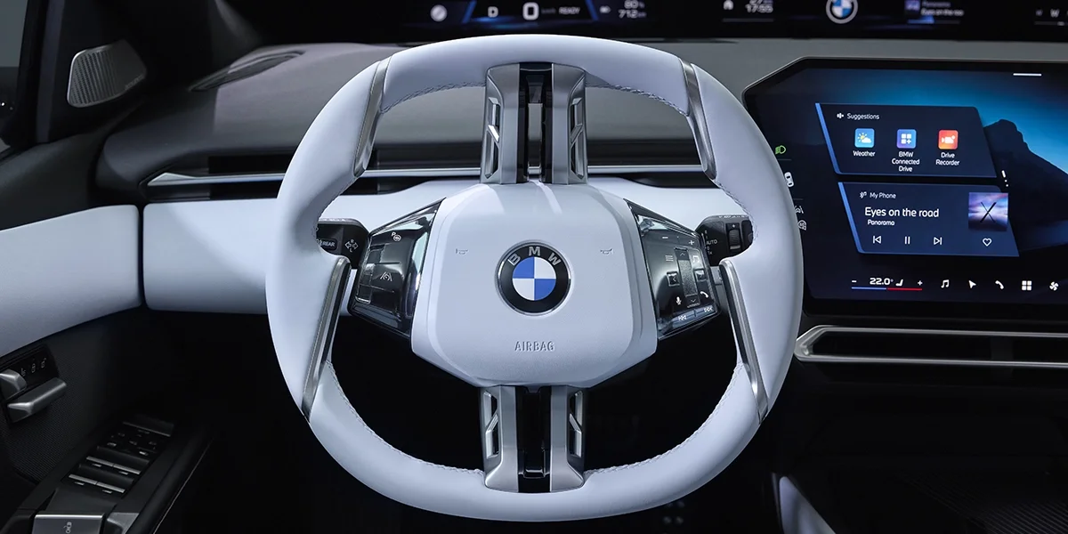 BMW i3 steering wheel with integrated controls and digital interface.
