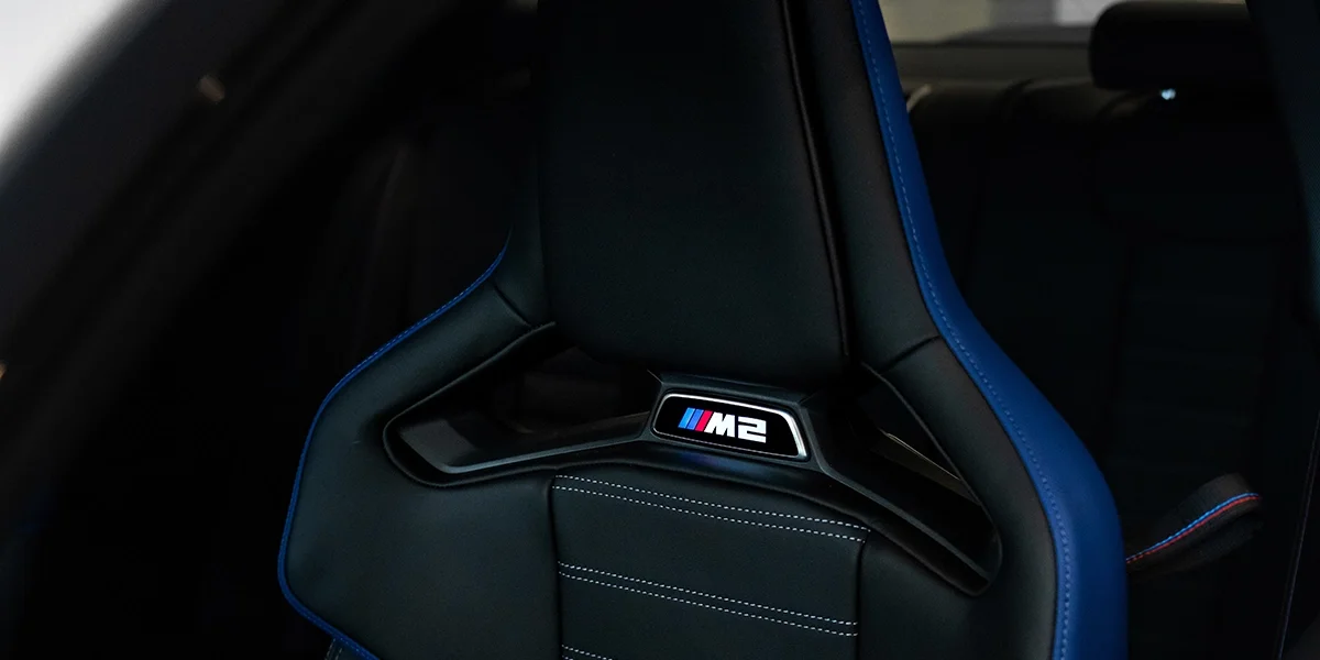 BMW M2 illuminated sport seat with blue stitching and M logo detail inside 2026 M2 Turbo Coupe.