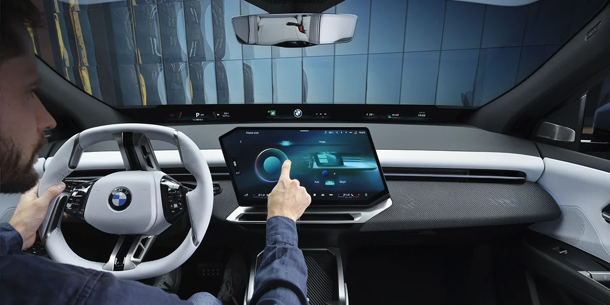 BMW iX3 50 xDrive cockpit showing digital dashboard and curved display touchscreen.